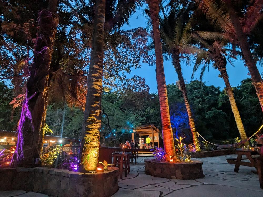 Terrasse de Roatan Island Brewing Co illuminée au crépuscule
